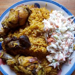 A picture of Jollof rice and salad.