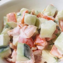 A picture of Cucumber and tomatoes salad.