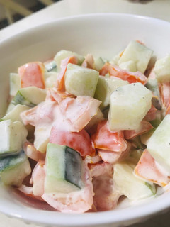 A picture of Cucumber and tomatoes salad.