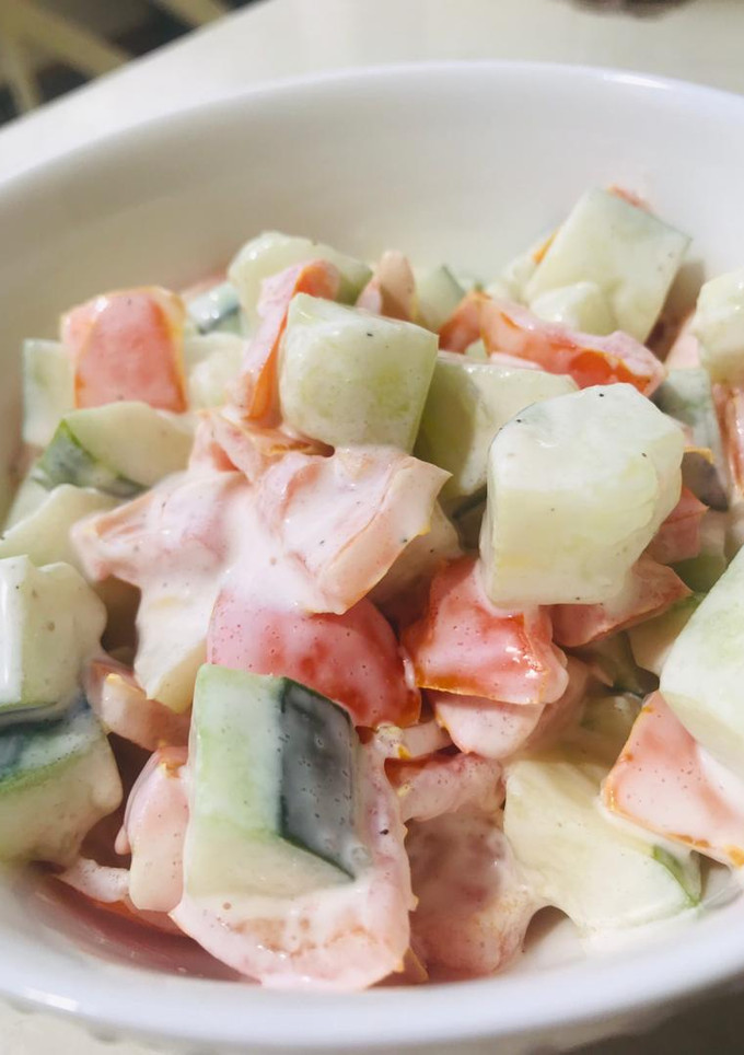 A picture of Cucumber and tomatoes salad.
