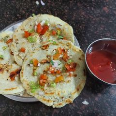 A picture of Suji uttapam with sauce.