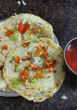 A picture of Suji uttapam with sauce.