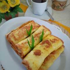 A picture of Roti tawar gulung celup telur.