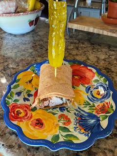 A picture of Mediterranean Grilled Chicken on a Tomato-Basil Tortilla Wrap.