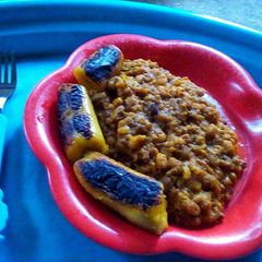 A picture of Onion Sauce Beans and toasted plantain.