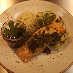 A picture of Marinated chimichurri salmon in oven served with spices rice.