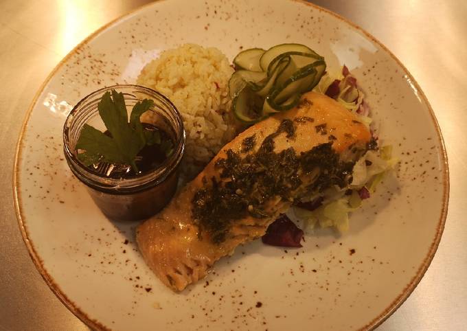 Marinated chimichurri salmon in oven served with spices rice