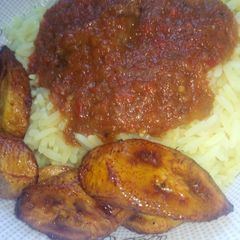 A picture of Curry rice with stew and Plantain.