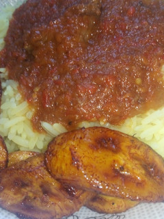 A picture of Curry rice with stew and Plantain.