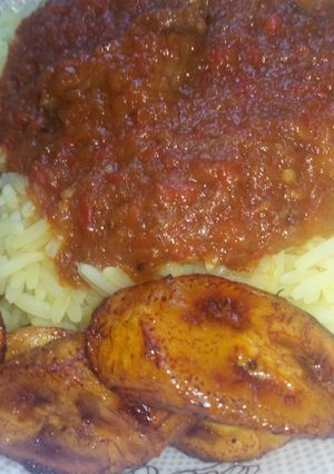A picture of Curry rice with stew and Plantain.