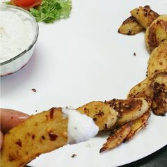A picture of Baked potato wedges with homemade cream cheese.