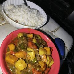 A picture of White rice and veggie sauce.