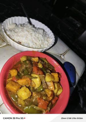 A picture of White rice and veggie sauce.