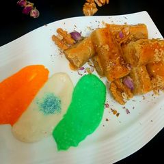 A picture of Walnuts baklawa served with cream.