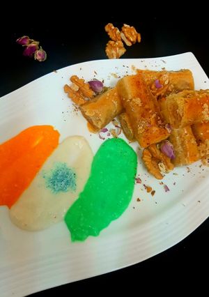 A picture of Walnuts baklawa served with cream.