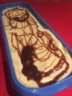Una foto de Helado crema de café con salsa de café y trocitos de brownie