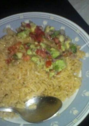 A picture of Rice with avocado and tomato salad.
