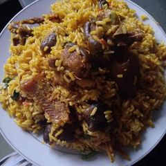 A picture of Palmoil rice with dry fish.