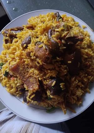 A picture of Palmoil rice with dry fish.