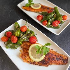 A picture of Tandoori Sea Bass with Garlic Padrón Peppers and Mango Chutney. 🐟🍋🌶🍅🫑.