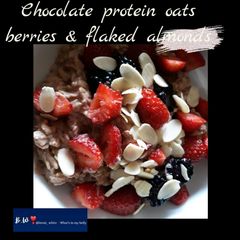 A picture of Chocolate protein oats with berries & flaked almonds.