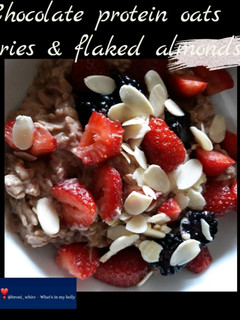 A picture of Chocolate protein oats with berries & flaked almonds.