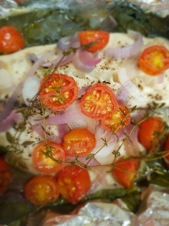 Una foto de Pescado empapelado con espinaca y jitomate uva