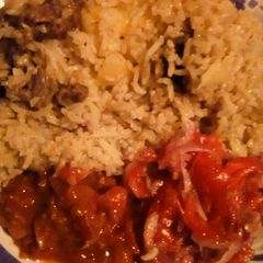 Pilau served with kachumbari and fried pepper A picture of Pilau served with kachumbari and fried pepper.
