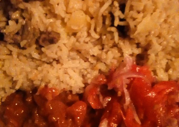 Pilau served with kachumbari and fried pepper