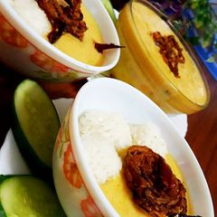 A picture of Kadhi with onion rings.