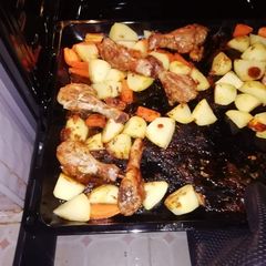 A picture of One pan meal baked Potatoes and chicken.