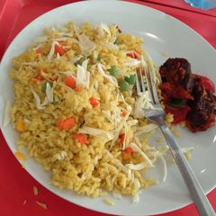 A picture of Jollof rice and fried meat.