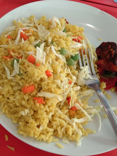 A picture of Jollof rice and fried meat.