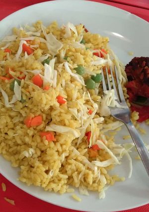 A picture of Jollof rice and fried meat.