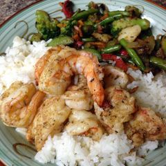 A picture of Grilled jumbo tiger shrimp and coconut rice.