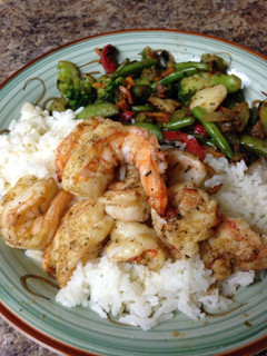 A picture of Grilled jumbo tiger shrimp and coconut rice.