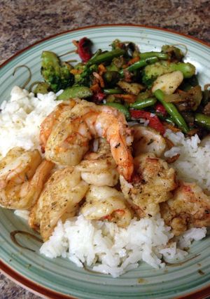 A picture of Grilled jumbo tiger shrimp and coconut rice.
