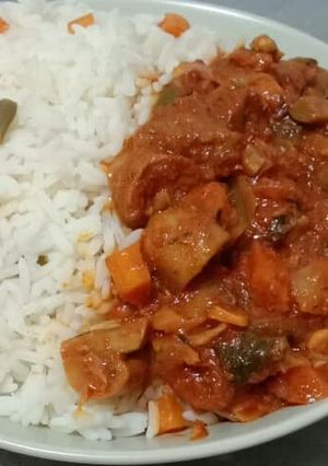 A picture of Beef and mushroom stew paired with garnished coconut rice.