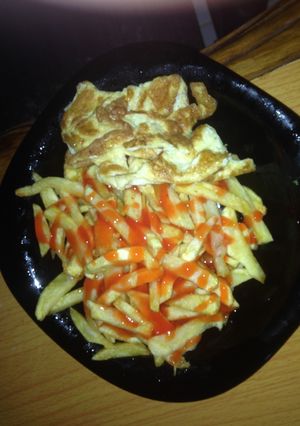 A picture of Fried egg served with French fries.