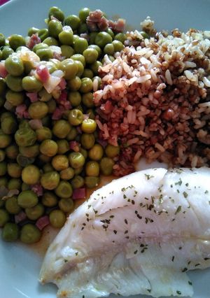 Una foto de Merluza con guisantes y guarnición de arroz