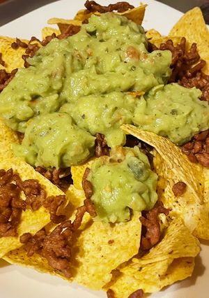 A picture of Nachos with Meat and Guacamole.