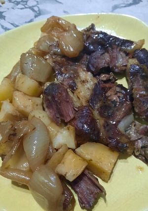 Una foto de Roast beef al horno con papa y cebolla