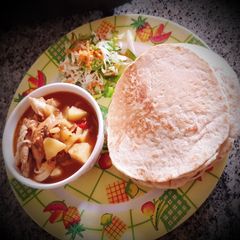 A picture of Oat flour chapatti with chicken curry.