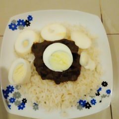 A picture of Rice with veggie egg sauce.
