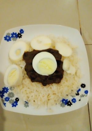 A picture of Rice with veggie egg sauce.