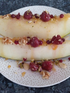 Una foto de Melón con frutas rojas, frutos secos y miel