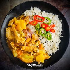 Spicy Pineapple Chicken and Basmati Rice with Mixed Chilli and Black Sesame seeds Garnish A picture of Spicy Pineapple Chicken and Basmati Rice with Mixed Chilli and Black Sesame seeds Garnish.