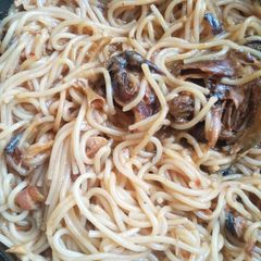 A picture of Jollof spaghetti with dried fish.