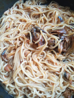 A picture of Jollof spaghetti with dried fish.