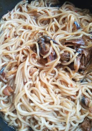 A picture of Jollof spaghetti with dried fish.